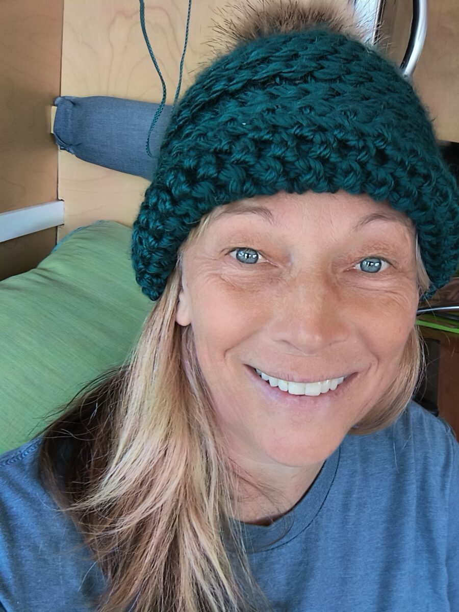 Nancy smiling in a green wool toque